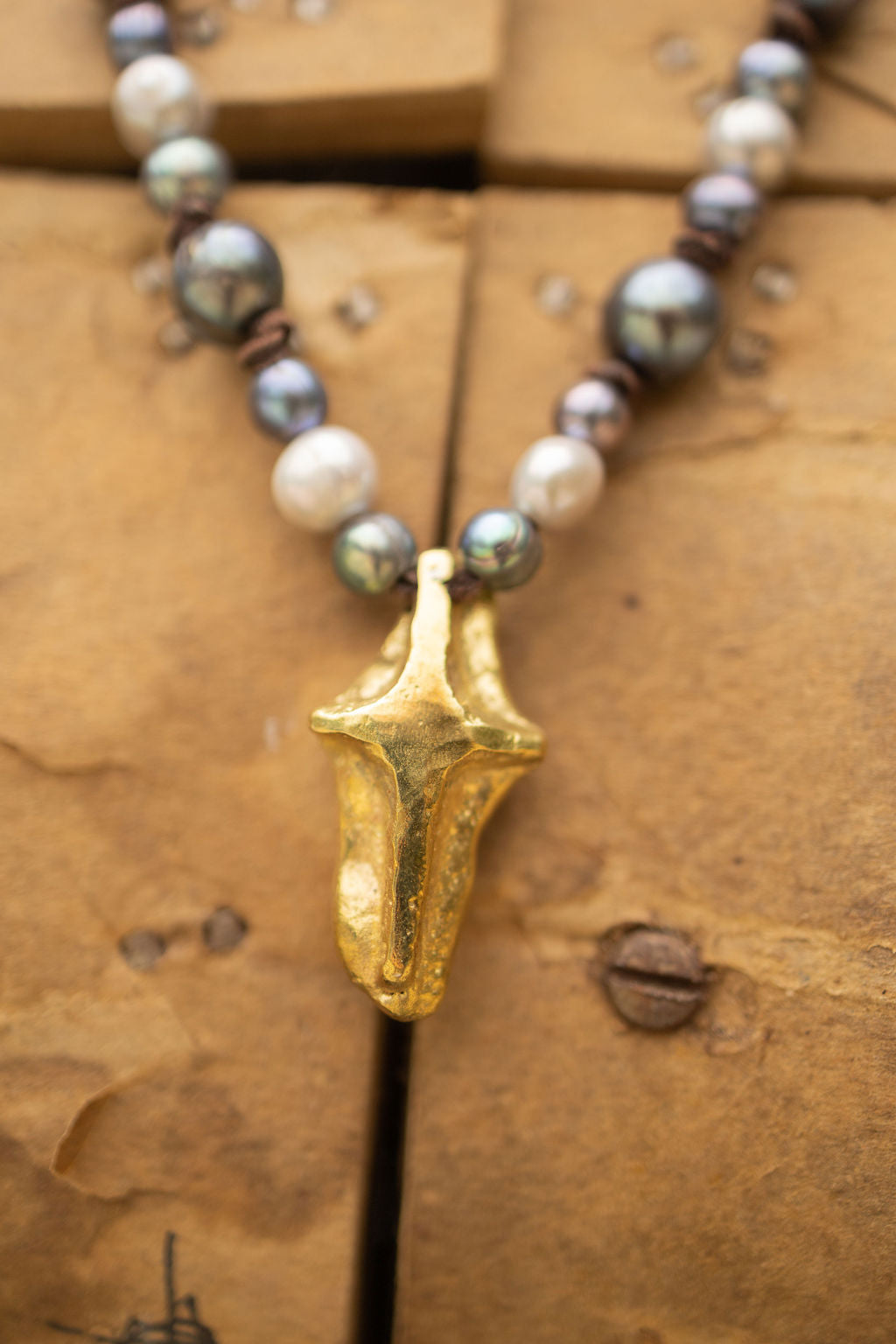 MODERN BRASS CROSS & GRAY PEARL NECKLACE